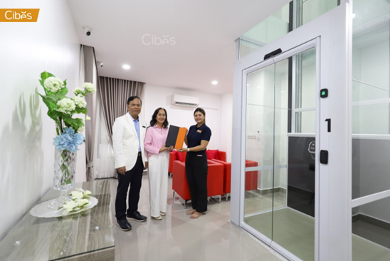White residential elevator in an existing home, showing a clean installation with minimal structural impact.
