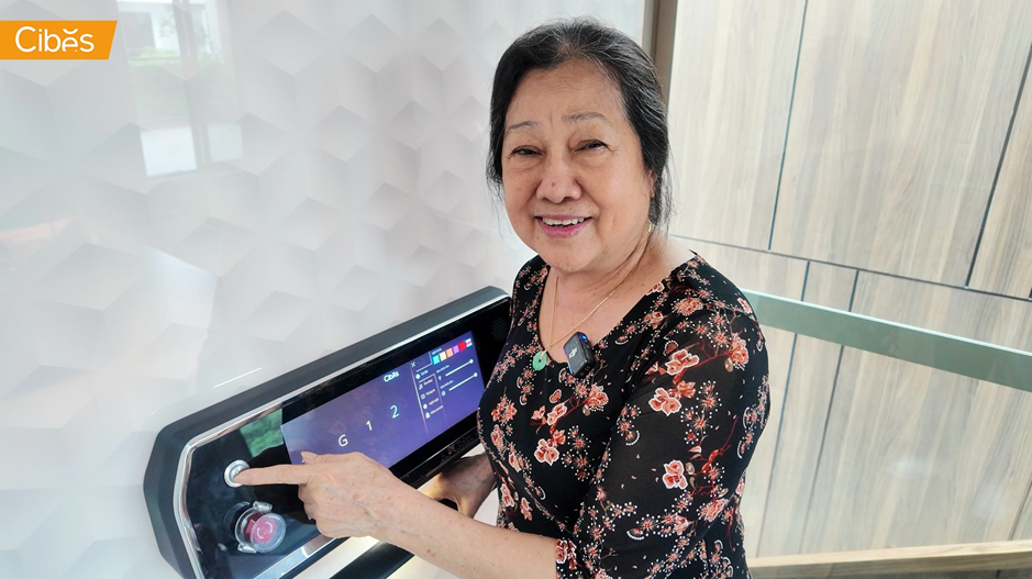 Elderly homeowner using a simple touch control inside a modern home elevator.
